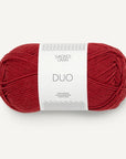 A skein of red Sandnes Garn Duo yarn with a label in the center displaying the brand and product name.