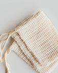 Stack of woven agave fiber soap saver bags with drawstrings