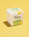 A white unscented solid dish soap cube with green and yellow packaging, labeled 'Make Nice Company - Unscented Solid Dish Soap'.