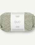 A skein of green tea Sandnes Garn Duo yarn with a label in the center displaying the brand and product name.