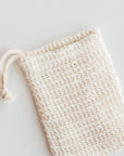 Natural agave fiber soap saver bag with a drawstring on a white background