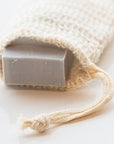 Agave soap saver bag holding a gray bar of soap, with a knotted drawstring