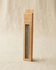 Cocoknits ruler and gauge set in a cardboard box on a beige background