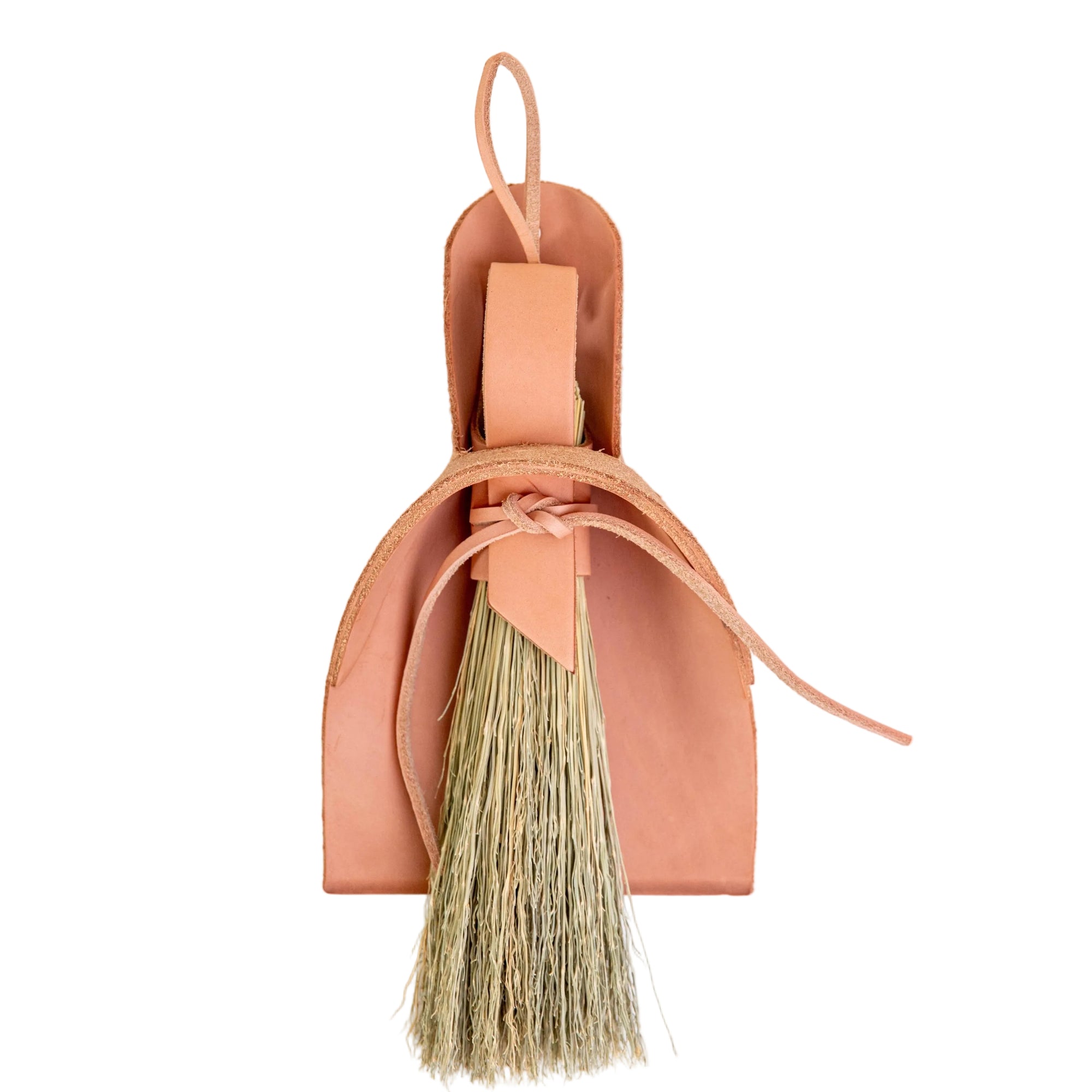 Natural leather dustpan and broom on a white background