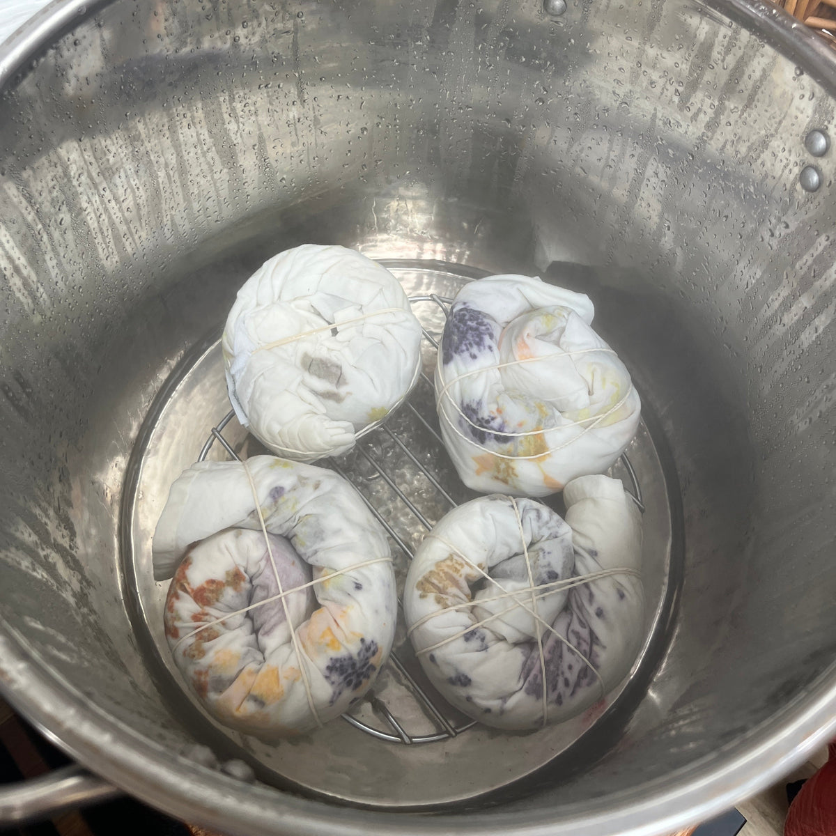 Steaming bundles of tea towels with flowers for dyeing