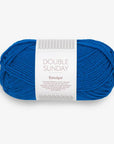 Blue skein of yarn with a label on a white background
