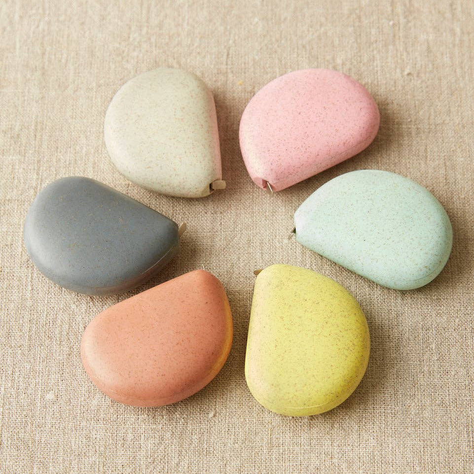 Set of colorful stones on a textured beige surface