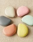 Set of colorful stones on a textured beige surface